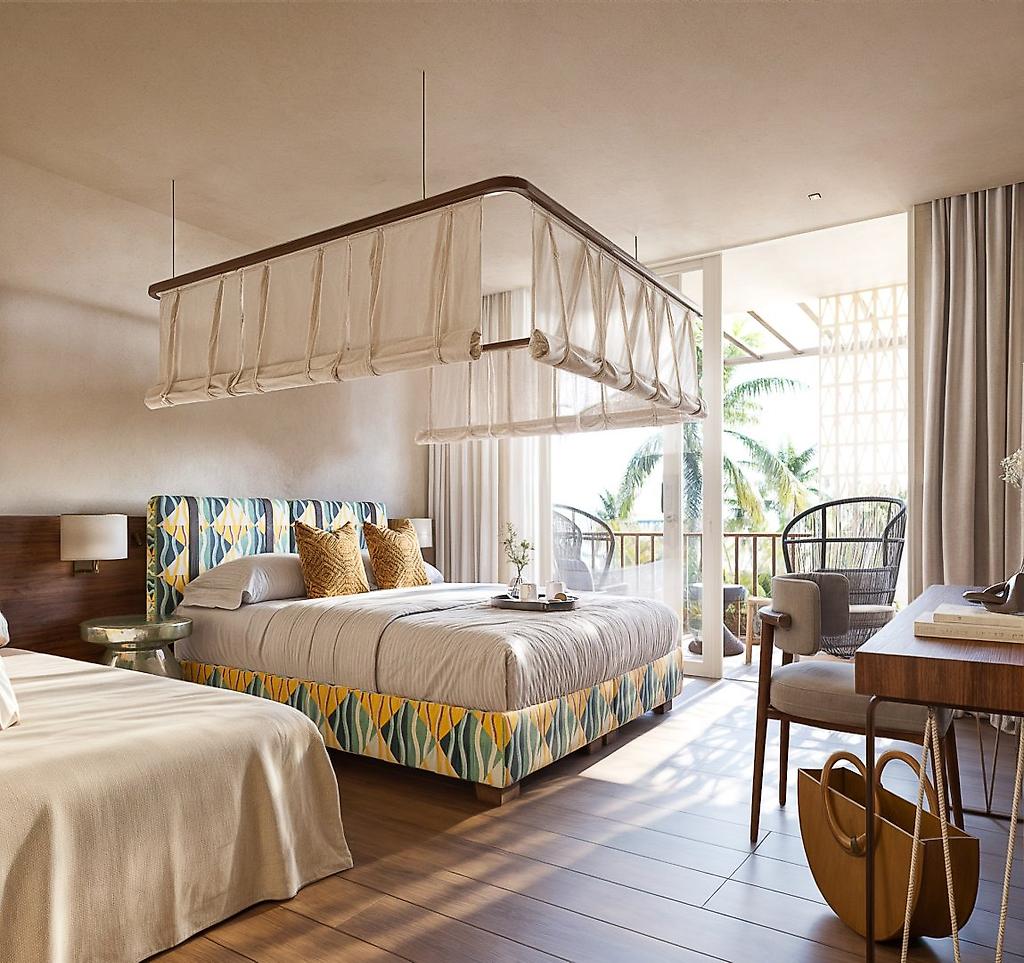 VOI Vila Do Farol Resort, Blick in ein geschmackvoll eingerichtetes Zimmer mit Sitzecke und Flatscreen-TV.