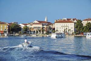 Blick auf Porec vom Wasser aus mit Booten und bei blauem Himmel Istrien